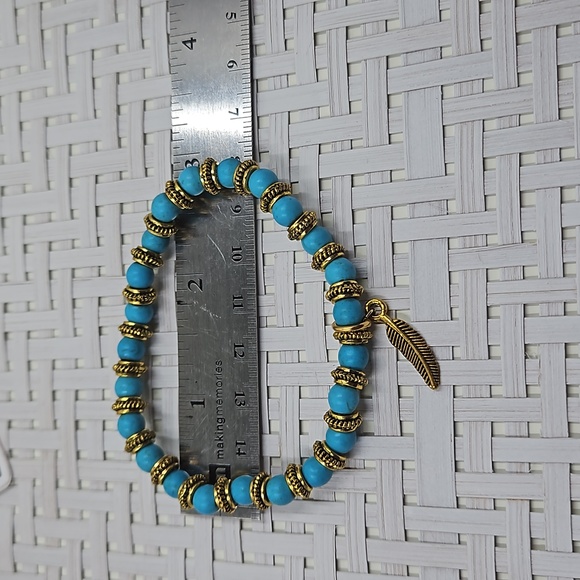 Handmade blue howlite and gold spacer bead stretch bracelet with a gold feather - Picture 2 of 3